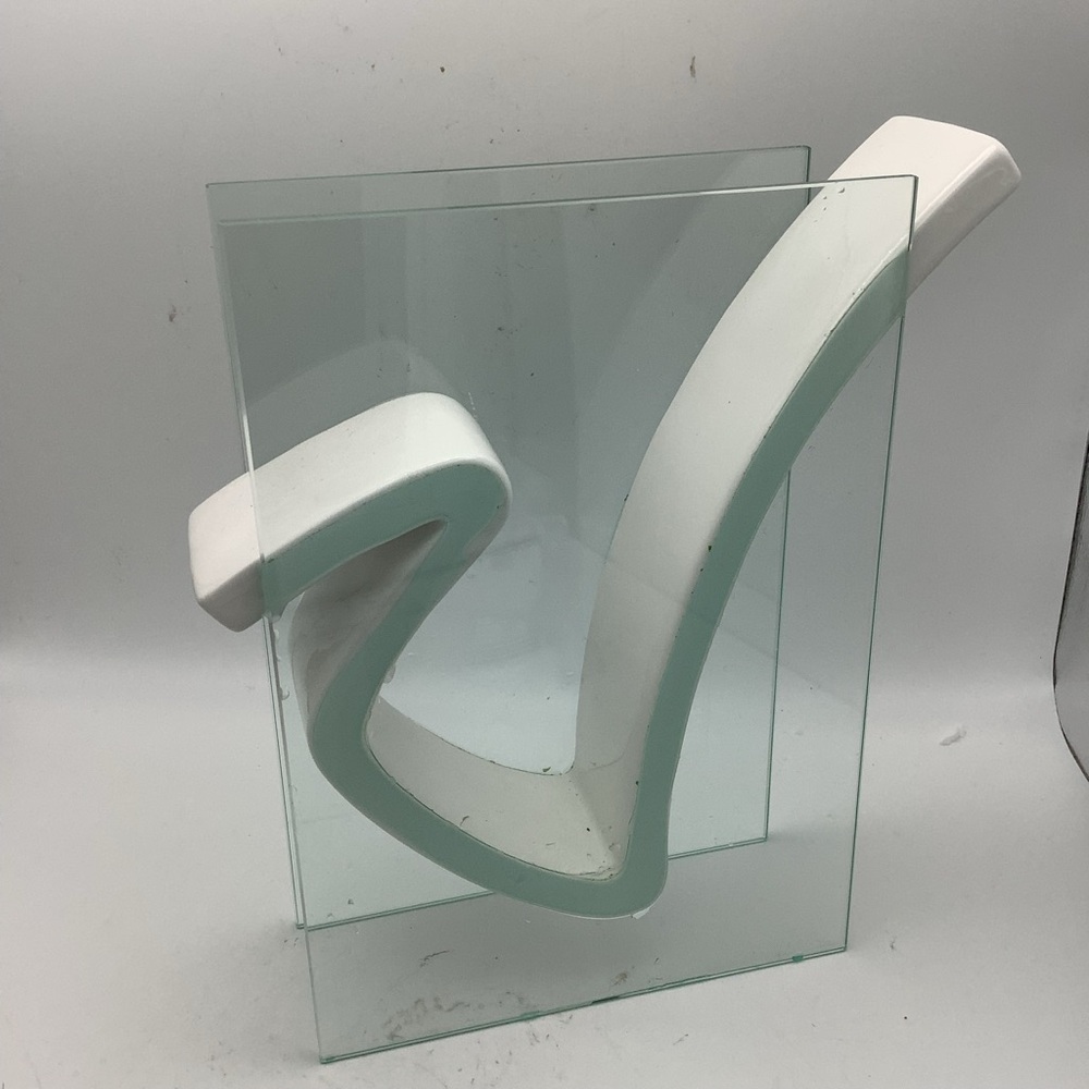 Modern White Sculpture Floating Between Two Clear Glass Panels.